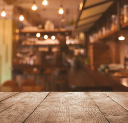 Empty wooden table in cafe. Bokeh effect