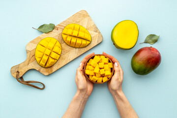 Tropical mango slices and cubes in wooden bowl