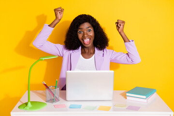 Photo of young happy crazy excited smiling afro woman work laptop raise fists in victory isolated on yellow color background