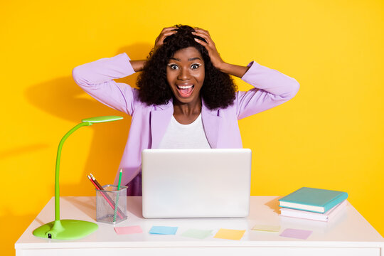 Photo of young beautiful happy crazy afro woman working in laptop winning lottery isolated on yellow color background