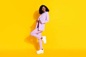 Fototapeta na wymiar Full size photo of young lovely smiling afro businesswoman dancing look copyspace isolated on yellow color background