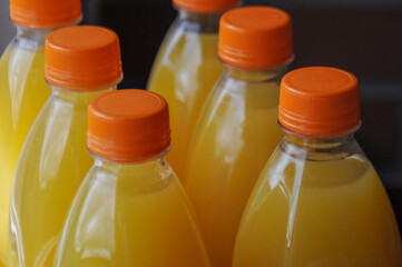 Close up on the multi-pack of plastic bottles with orange juice