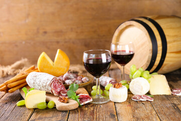 red wine glass with cheese and salami