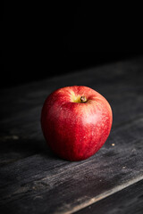 red and organic apple on a table