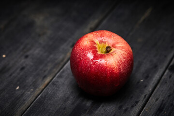 red healthy red apple on wooden table