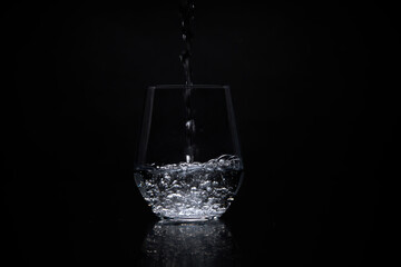 a clear glass of purified water on table