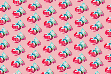 Creative pattern made of colorful macaroons on pink background. Dessert and confectionary concept.