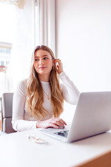Blond woman working on her laptop at the office