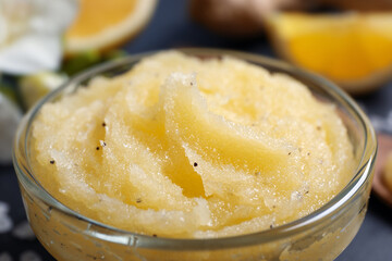 Body scrub in glass bowl on table, closeup