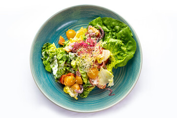 Vegetable salad in a blue plate 