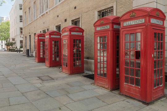Traditional red telephone boxes in a London street.