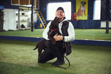 Happy instructor and his affectionate canine friend