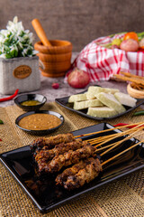 Pork Satay or Sate Babi. Pork Satay served with a Peanut sauce and slices of lontong or ketupat (rice cakes)