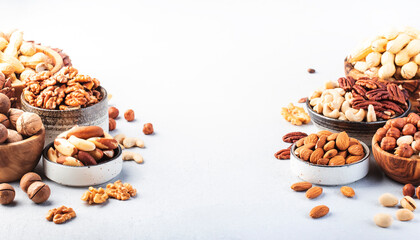 Assortment of nuts. Cashews, hazelnuts, walnuts, almonds etc. Healthy Food Snacks mix on gray background, copy space