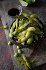 Coconut bowl with fresh edamames  ready to eat. Delicious edamames. Vegetarian and vegan food. Vegan protein