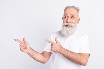 Photo of cheerful grey hair beard old man point look empty space wear white t-shirt isolated on grey color background