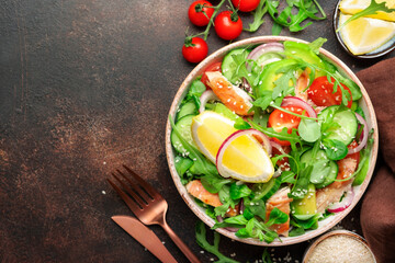 Salad with grilled chicken, tomatoes, arugula, red onion, avocado, sesame seeds and lemon oil dressing. Healthy food. Top view