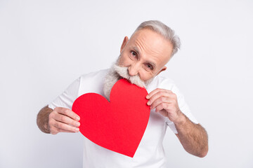Photo of hungry old grandfather bite red paper big heart shape figure isolated on grey color...
