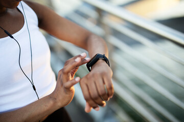 Close up of female runner using smart watch