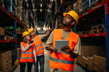 Manager visits warehouse. Warehouse worker with tablet