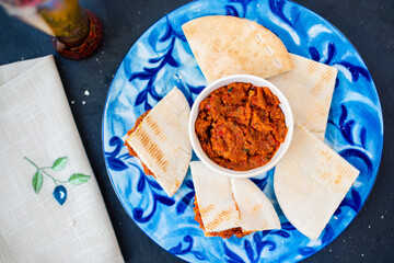 Red paste of dried tomatoes and peppers with pita - Mediterranean breakfast 