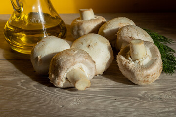 The fresh champignon mushrooms ready for cooking. A top view closeup of fresh mushrooms.