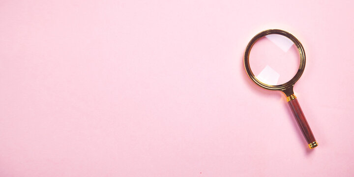 Magnifying glass on the pink background.