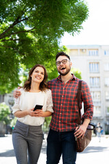 Naklejka premium Happy young couple outdoors. Loving couple walking in the city.