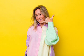 Young australian woman isolated showing a mobile phone call gesture with fingers.