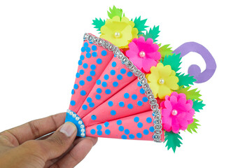 A crafted handmade umbrella made for small children held-ed by a person with his hand