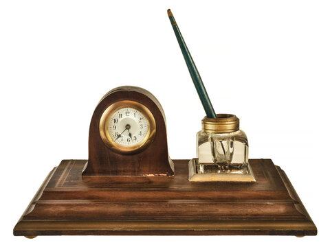 Vintage wooden inkstand with pen, glass ink pot and small clock isolated on white