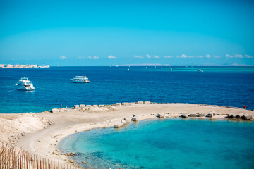 
View of coast of Hurghada and ship in sea. Seafront Hurghada. View of Egyptian city of Hurghada from Red sea.