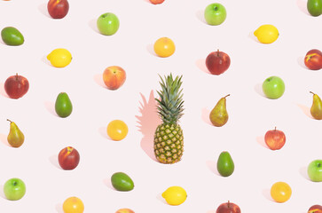 Different fruit pattern on pastel pink background with big pineapplee in the middle. Aestetich modern concept. Summer background.