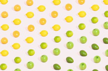 Different yellow and green fruit pattern on pastel pink background. Colorcolorful summer concept.