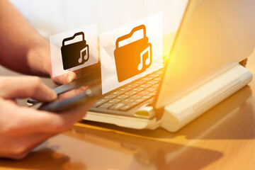 A man is looking for music on the Internet. Music and internet. Copyright and music downloads