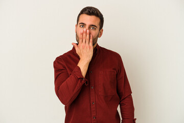 Young caucasian man isolated on white background shocked, covering mouth with hands, anxious to discover something new.