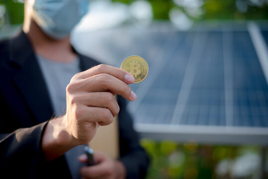 businessman's hand is holding the Bitcoin coin..Bitcoin concept Bitcoin and renewable energy