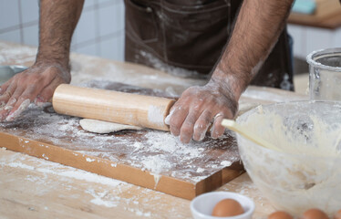 Pizza dough preparation by chef.
