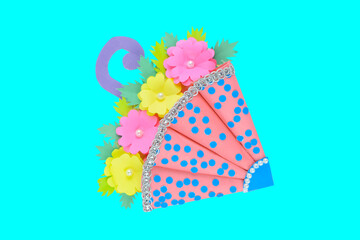 A pink and blue colored handmade crafted umbrella placed on a white paper