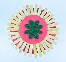 A round decorative design made with many small sticks stacked all together