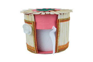 A tissue box made with some small wooden ice cream sticks stacked together