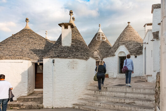 Tourists exploring the Trulli village in Alberobello