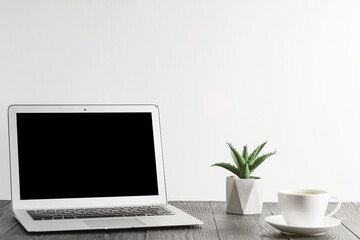 people sits on a work with a laptop computer for a wood table on the blackboard background