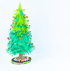 Christmas tree made with small craft paper and nicely placed on a paper background