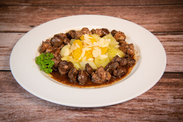 Recipe of sweetbread and lamb kidney with cocoa, leek whistles with almonds and oranges. High quality photo