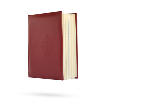 Red book isolated on white background. Levitation.