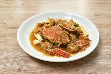 stir fried swimmer crab in yellow curry and egg on plate