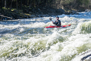 Extreme kayaker in the middle of rapid