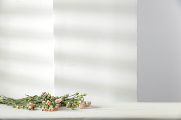 White wooden desk of free space and fresh flowers decoration. 