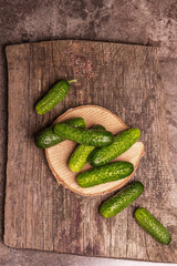 Crispy cucumbers on a wooden stand, marble background